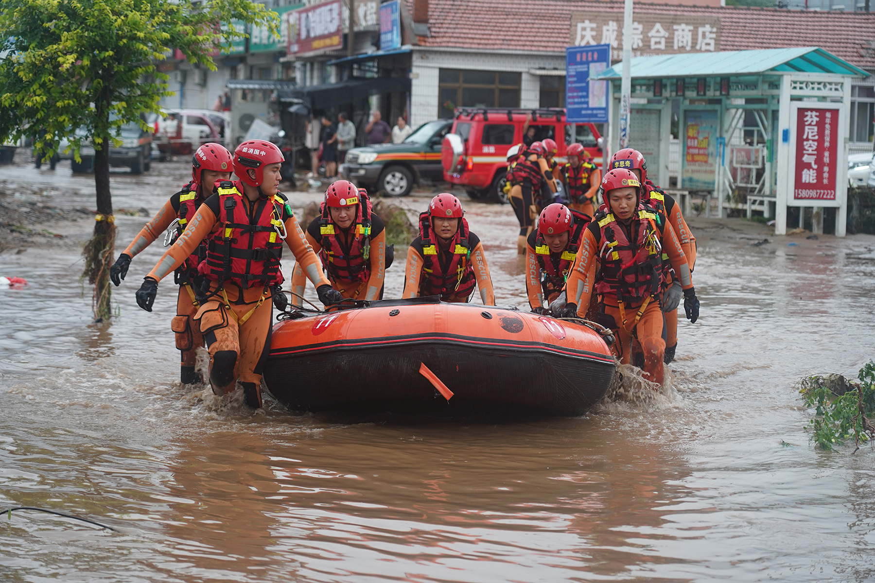 8月20日，遼寧省葫蘆島市建昌縣，消防員抬著舟艇向受災區行進。遼寧省消防救援總隊供圖